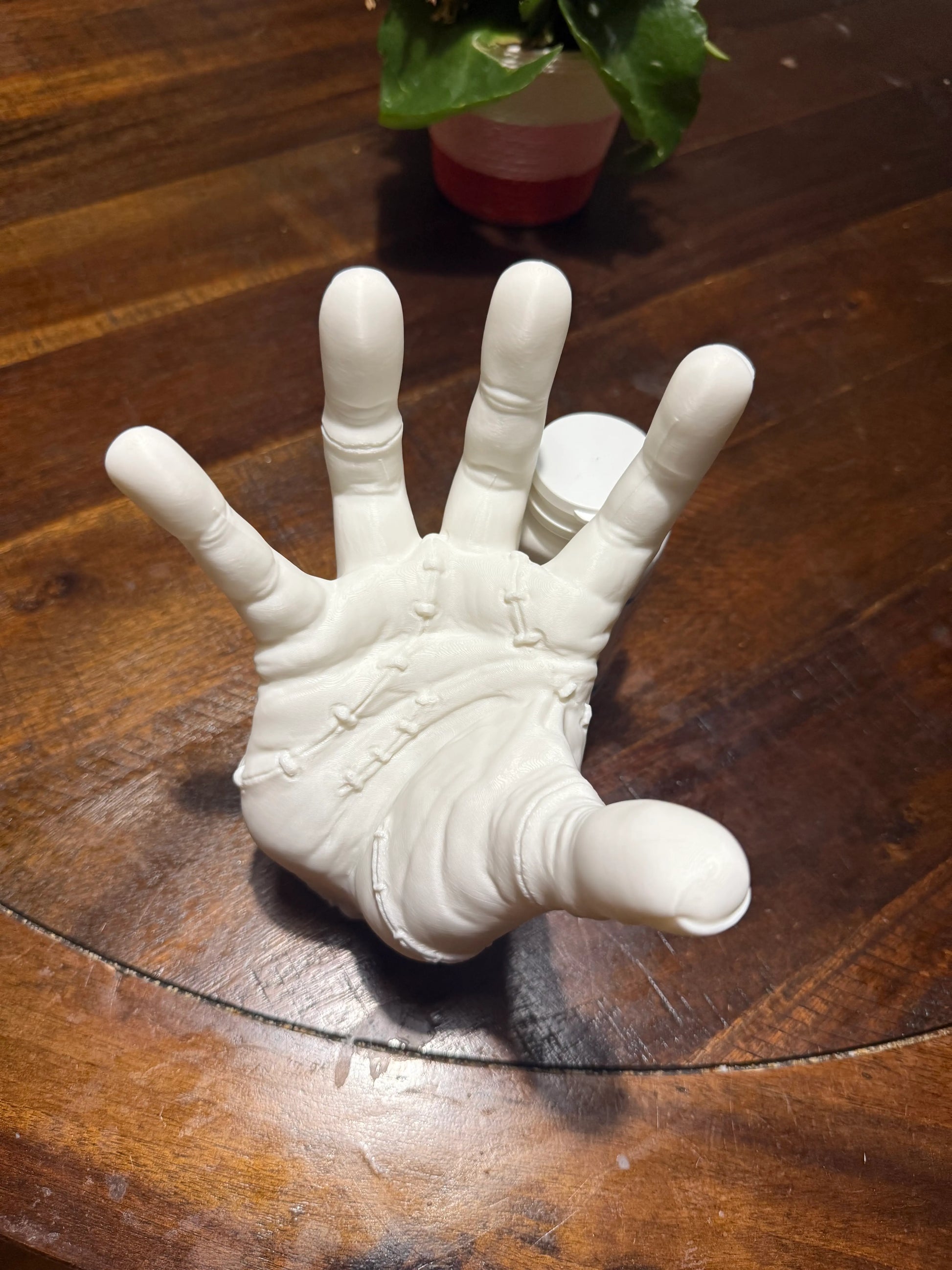 3D printed Addams Family Thing hand cosplay prop replica in white PETG, top view showing detailed palm and stitches