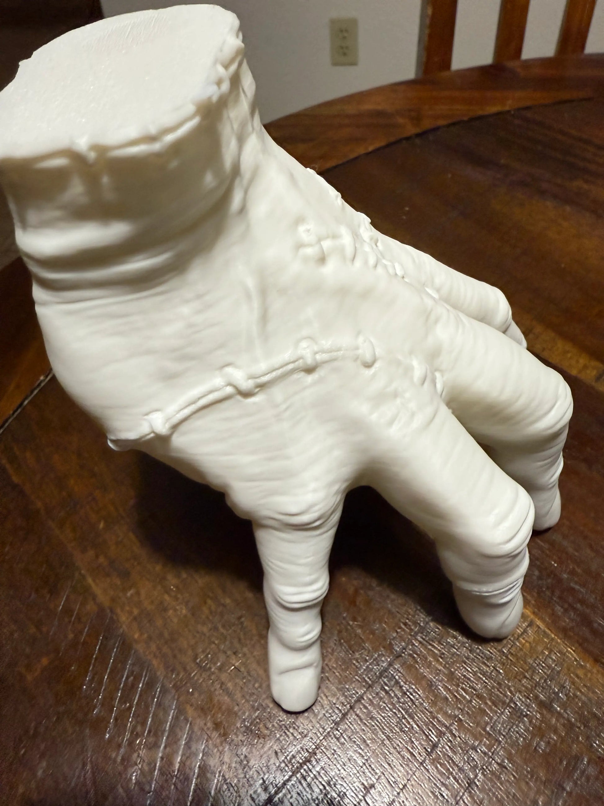 White 3D printed Addams Family Thing hand prop, cosplay display model with lifelike wrinkles and stitch detail
